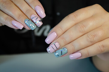 Hands of a young woman with a manicure and gel Polish.
