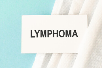 Word lymphoma with medical mask on a blue background. Medicine concept