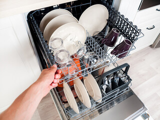 dishwasher close-up with washed dishes, easy to use and save water, eco-friendly, built-in kitchen dish washing machine
