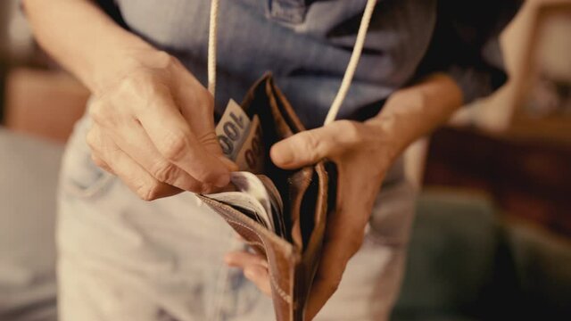 Hands are counting Turkish banknotes in the wallet