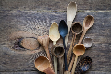 Top view lot of wooden spoons made of precious wood on wooden table, eco-friendly concept of...