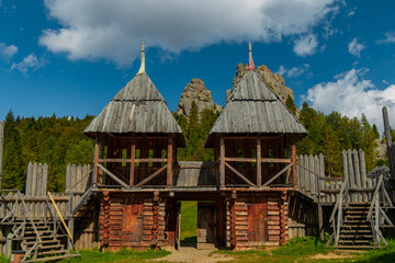 ancient fortress wooden defence building with two towers and gate in wilderness highland mountain forest outdoor environment