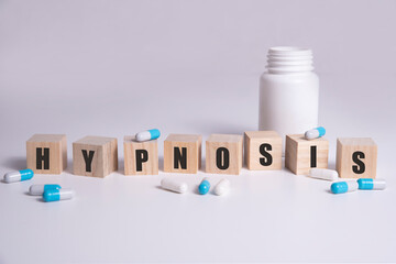 HYPNOSIS word made with building blocks with pills.