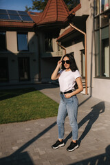 Beautiful brunette model posing to photographer outdoors