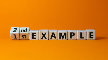 Turned a cubes and changed the expression '1 st example' to '2nd example'. Beautiful orange background. Business concept. Copy space.
