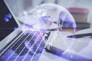 Double exposure of financial chart drawing and desktop with coffee and items on table background. Concept of forex market trading