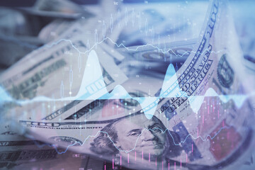 Fototapeta premium Double exposure of forex graph drawing over us dollars bill background. Concept of financial markets.