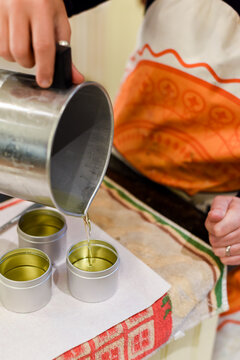 Creative Occupation Of Candle Making Showing The Pouring Of Liquid Wax Into Jars