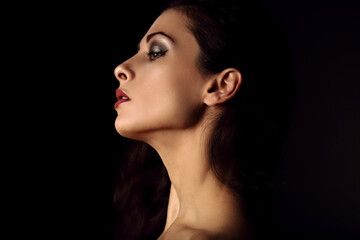Fototapeta premium Beautiful makeup woman with elegant healthy neck, nude back and shoulder on black background with empty copy space. Closeup profile view portrait. Art.