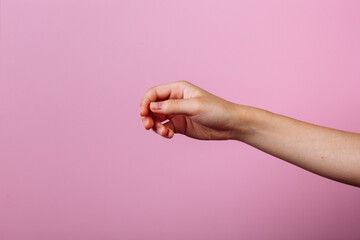 Instruction: how to hold chopsticks eat with chopsticks. Isolated on pink background. step 1.