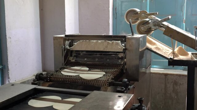 Naan Making Machine - Flattened Dough Runs Down Conveyer Belt