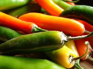orange and green fresh hot peppers, close up
