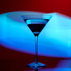 Martini glass on a red background with blue lights.