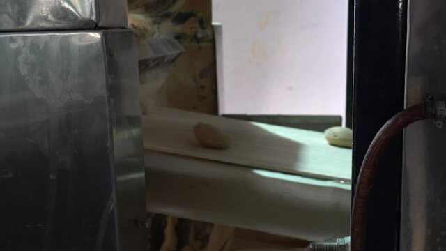 Naan Making Machine - Process Starts With Dough Balls On Conveyer Belt