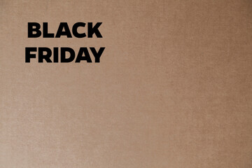 Cardboard box with black friday order written on the box placed on the floor in an empty room with a neutral background. delivery concept. economy concept. black friday concept. shopping concept. 