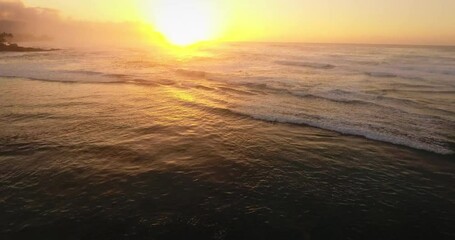 Tilt up aerial, Hawaiian ocean waves at sunset - Powered by Adobe