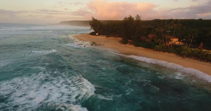 Wide aerial, Hawaiian beach coastline at sunset