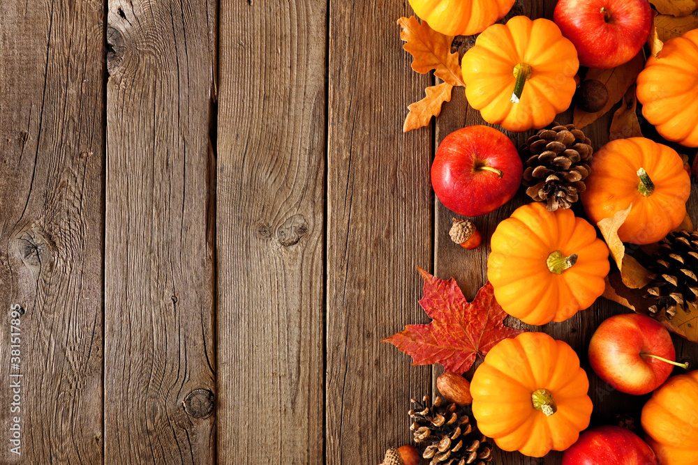 Aufkleber Fall side border with pumpkins, leaves and apples. Above view on a rustic dark wood background with copy space.