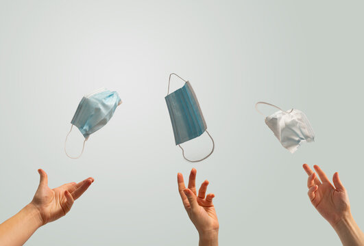 After Coronavirus concept, people throwing away their surgical, protective masks in the air. Copy space