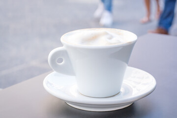 Blurred background with a cup of cappuccino