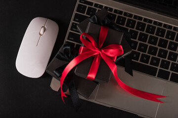 Black Friday sale online shopping commerce, Top view of gift box wrapped black paper and red bow...