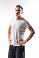 sporty man in white t-shirt on a light background gesturing with his hands cropped view Copy Space