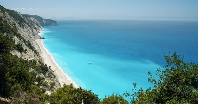 Luxury sail yacht boat in turquoise blue sea lagoon near Egremni beach, Lefkada island, Greece.