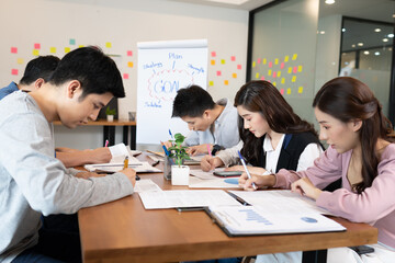 Fototapeta premium Business team writing requirement and marketing plan for brainstrom and discussion in meeting day,Business startup concept