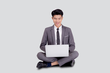 Young asian business man sitting work on laptop computer to internet online isolated on white background, businessman confident and notebook, freelance with success, marketing and communication.