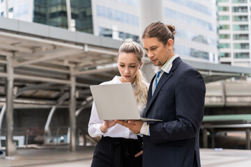 Business people with laptop computer discussion and work together at outdoor