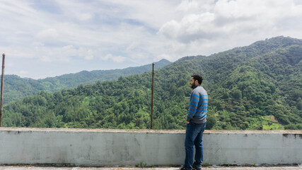 Fototapeta na wymiar Man enjoying mountain view in San Juancito Fracismo Morazan Honduras Central America