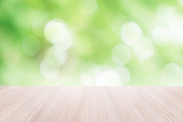Naklejka na ściany i meble Empty wooden table top with blurred defocus natural green bokeh background, aesthetic creative design