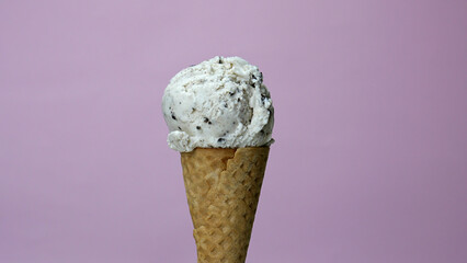 Ice cream Cookies & Cream scoop in waffle cone, Front view Food concept.
