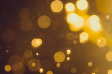 Dark Abstract Gold bokeh sparkle on black background