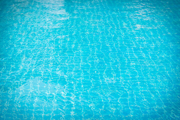 Reflections from the water in the blue swimming pool