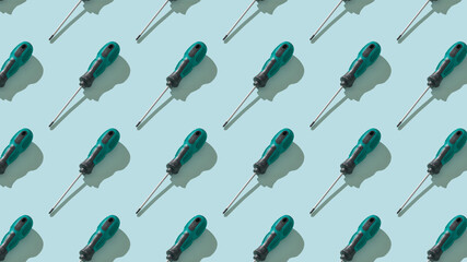 Seamless pattern of screwdrivers with a black and green handle.