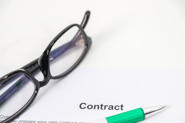 Sign on contract document with fountain pen and glasses
