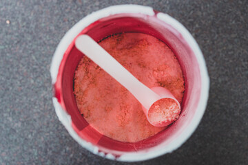 open jar of protein powder supplement shot from top down perspective