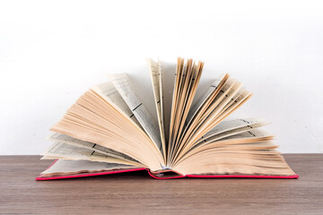 An open book on the table in front of white background