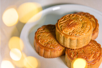 Chinese food Mooncakes on plate. Chinese bakery product traditionally eaten during the Mid-Autumn Festival. 