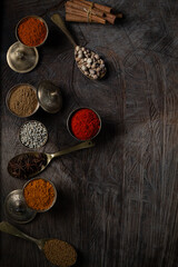 Fototapeta na wymiar Condiment of indian food Spice garnish background on wood table top view. Seasoning of Asian organic herb cuisine flavour in kitchen board, chilli spicy taste concept