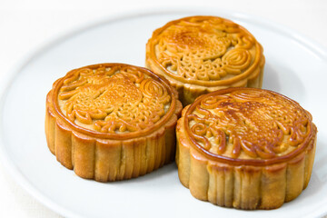 Chinese food Mooncakes on plate. Chinese bakery product traditionally eaten during the Mid-Autumn Festival. 
