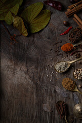 Condiment of indian food Spice garnish background on wood table top view. Seasoning of Asian organic herb cuisine flavour in kitchen board, chilli spicy taste concept