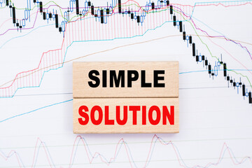 Wooden cubes with letters on the table in the office. Text simple solution.