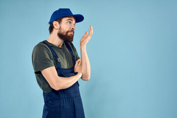 man in work uniform uniform professional work lifestyle delivery service blue background