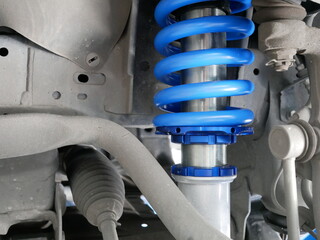 maintaining a car shock absorbers at garage.