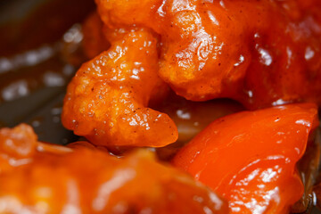 Extreme close up photo of sweet and sour chicken Chinese food.