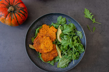 healthy home made pumkin patties with avocado and arugula salad