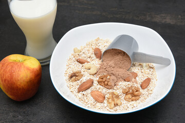 Home made protein bar or balls with whey protein powder, almonds, oats, walnuts, milk, honey or jaggery syrup. Healthy snack for body builders for muscle building in India. diet food. 