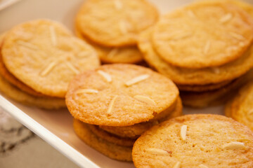 A plate full of delicious cookies with Almond slivers on top